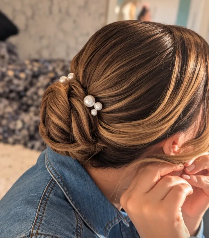 A pearl-pinned occasion hairstyle created by Becky