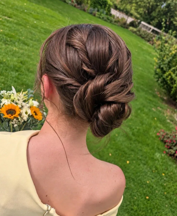 A softly sculpted low bun by Becky